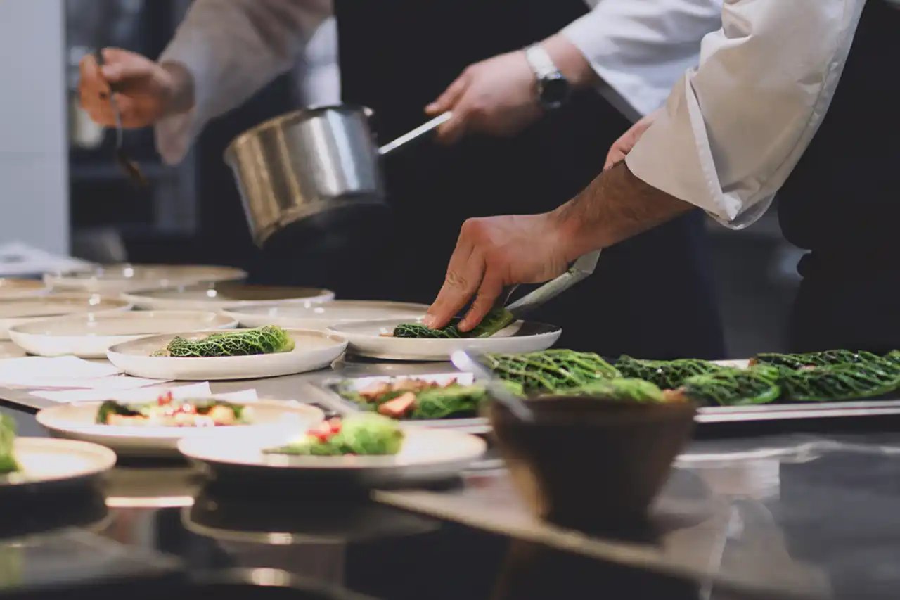 Deux élèves cuisiniers de l'école Ferrandi Paris préparant des plats
