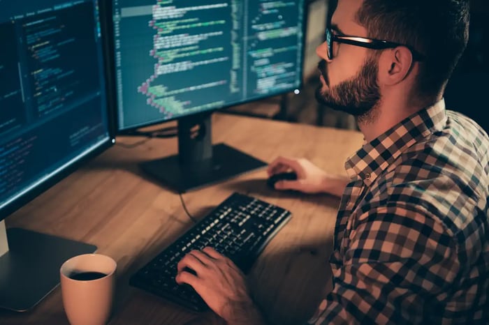 Développeur travaillant sur du code WordPress sur plusieurs écrans, dans un contexte de maintenance et développement web